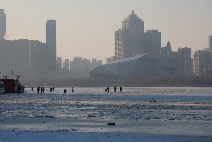 2026年1月4日，沈阳市民在浑河沈阳段的冰河上游玩、拍照，享受冬日时光。 