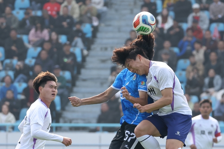 2026年3月25日，江苏常州，江苏常州与湖南永州足球友谊交流赛在常州奥体中心体育场举行，最终，常州队1比0战胜永州队。比赛过程中，双方球员拼劲十足，观赛球迷热情高涨。图为常州队球员（白衣）与永州队球员（蓝衣）在比赛中拼抢。