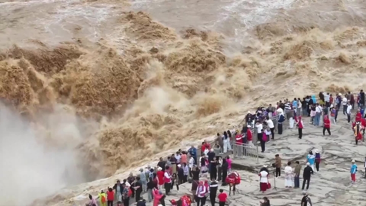 （视频截图）2026年5月25日，游客在山西省临汾市吉县黄河壶口瀑布旅游景区欣赏“金瀑飞流”壮美景观。日前，受黄河上游持续降雨影响，地处秦晋大峡谷的该景区水量骤增，瞬时流量超900立方米/秒，吸引众多游客慕名观赏。